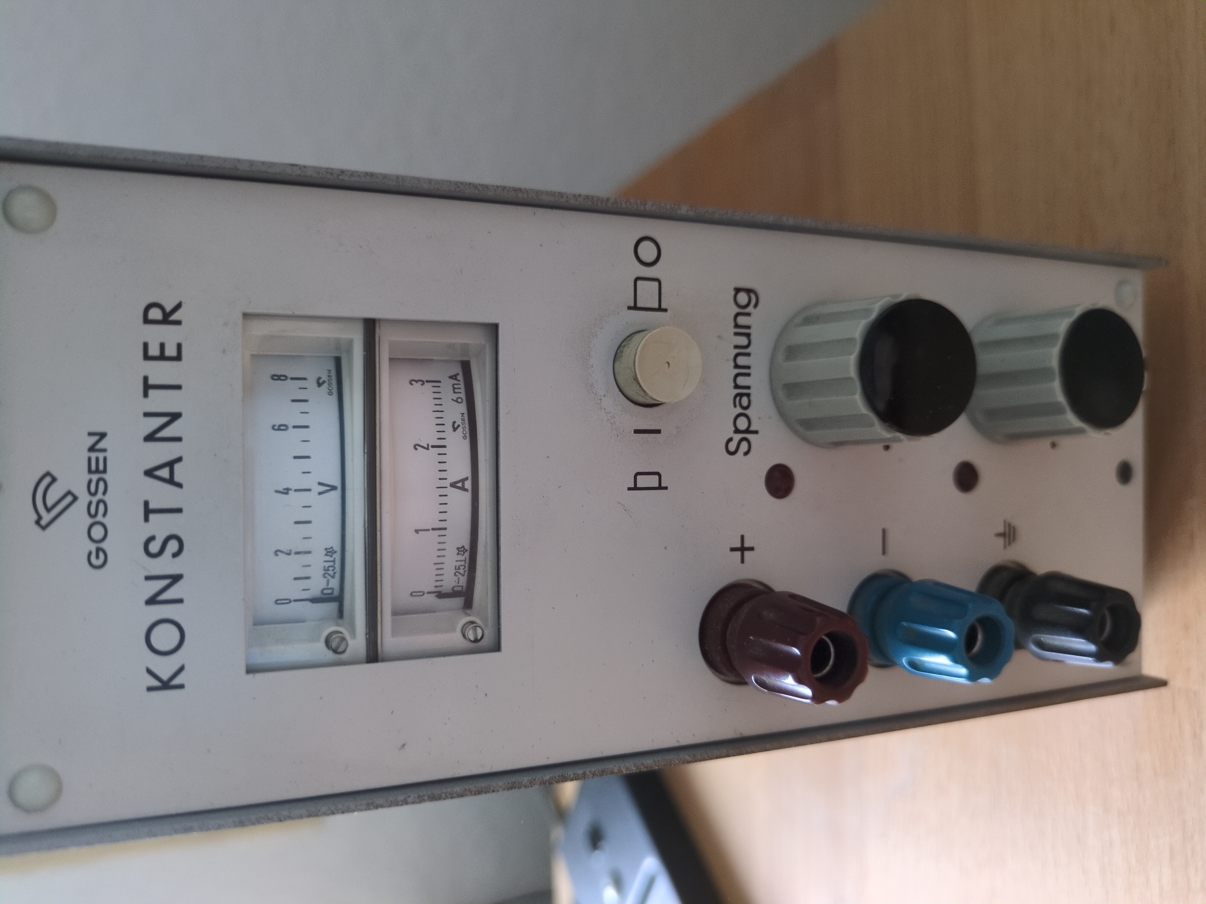 A Gossen Konstanster analog PSU standing on a wooden desk