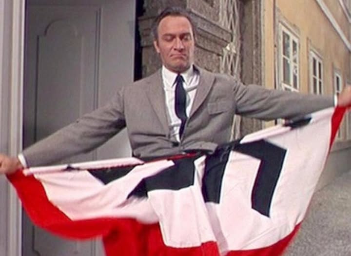 Picture of Captain Georg von Trapp, tearing up a Nazi flag Picture of Captain Georg von Trapp, tearing up a Nazi flag