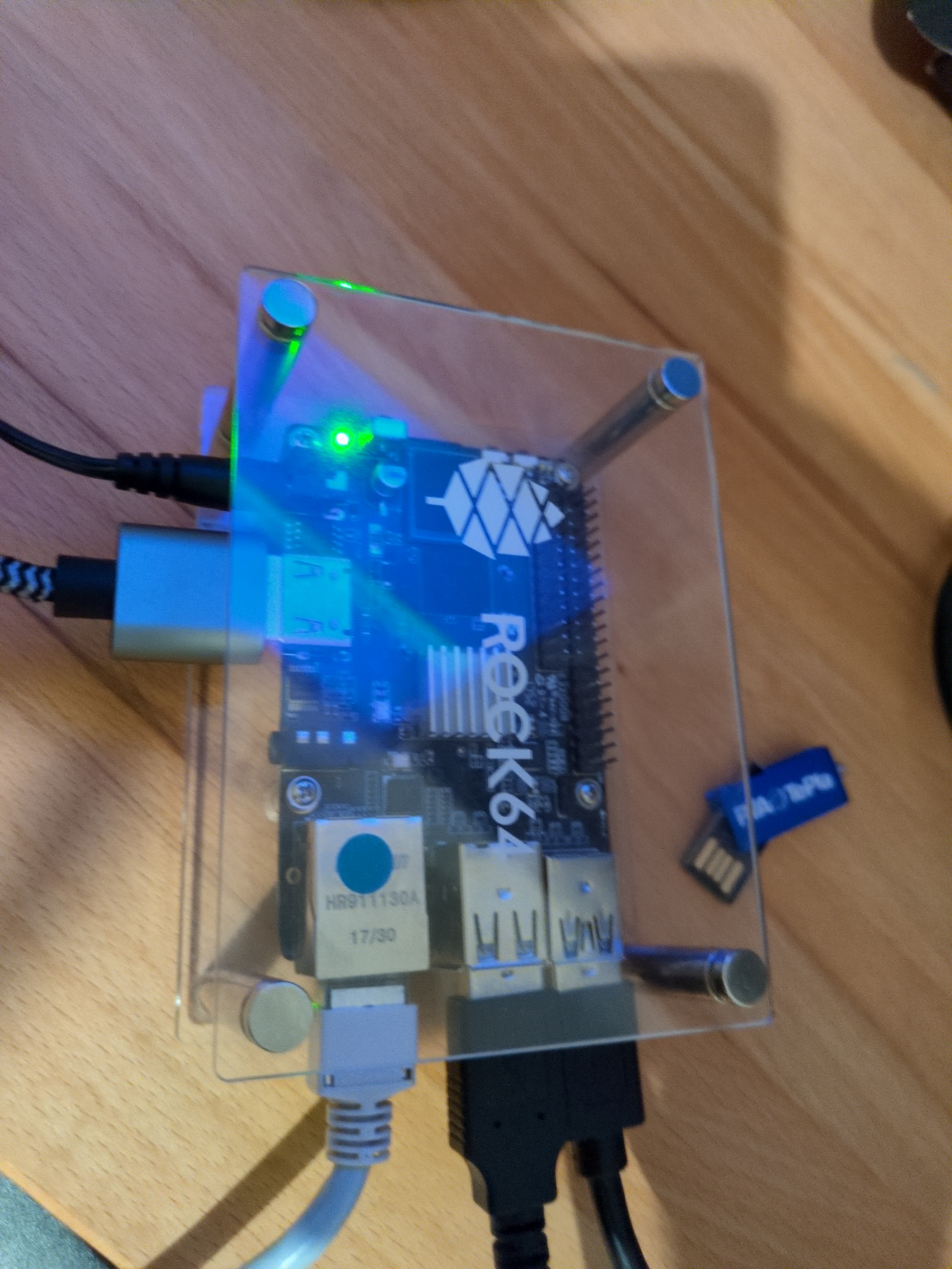 A rock 64 sbc sitting on a desk with various cables connected to it