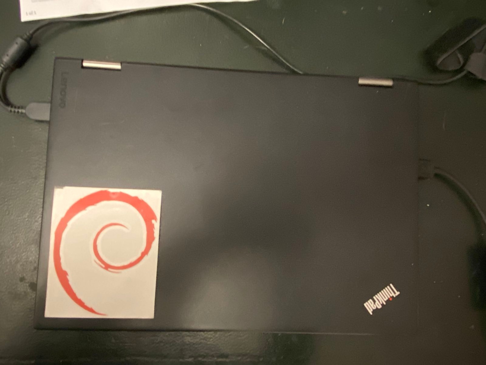 laptop with debian swirl sticker