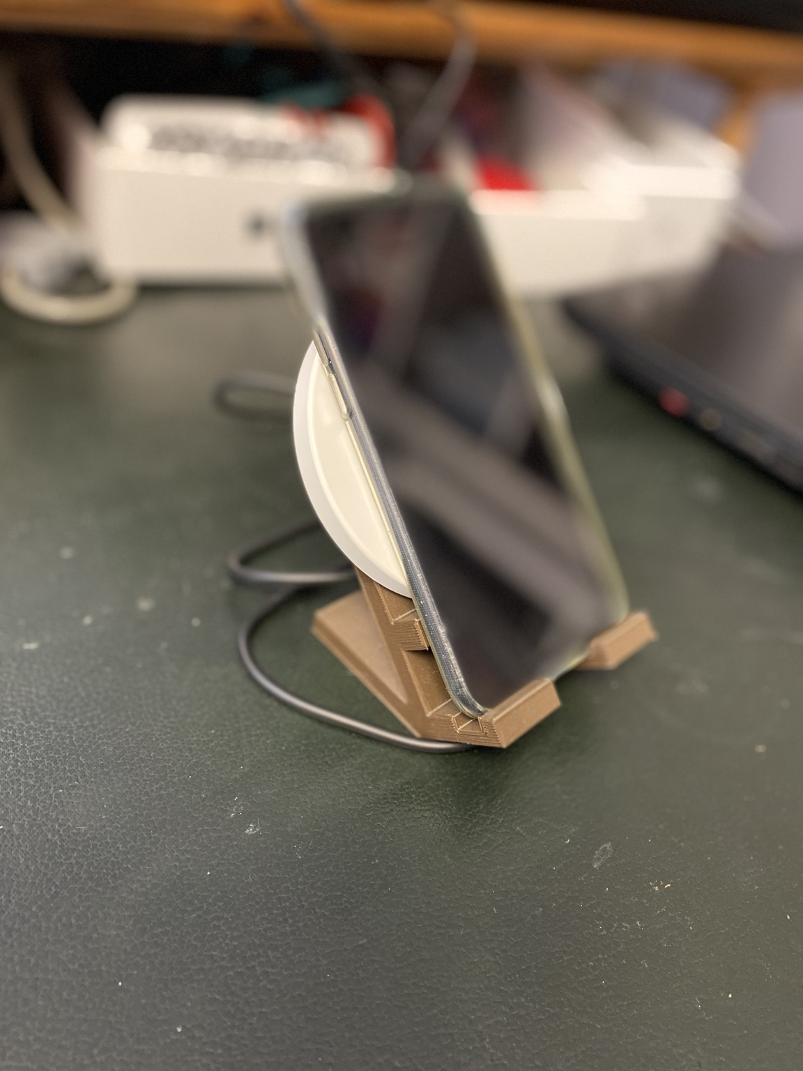 Phone on top of qi charger on top of stand 