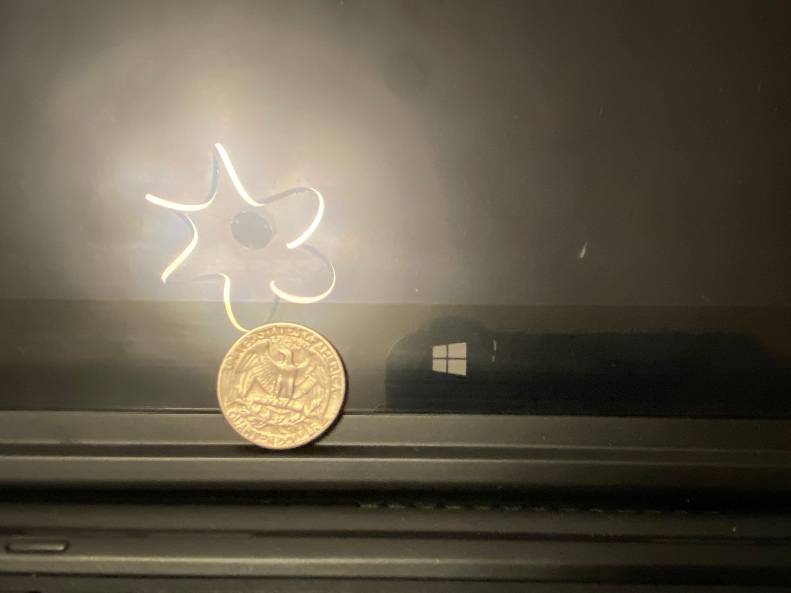 photo of laptop windows logo next to a US quarter coin