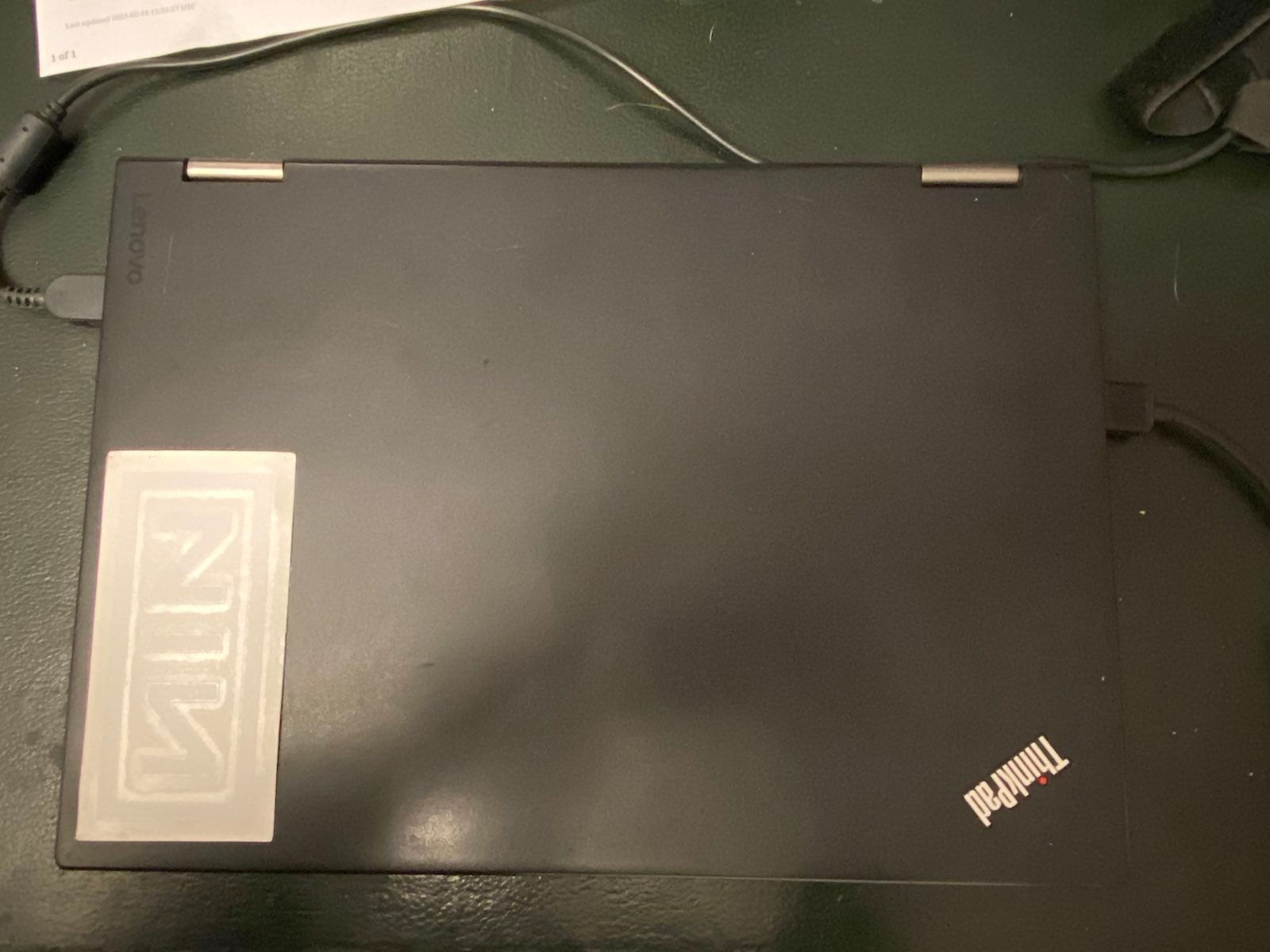 laptop with NIN logo sticker