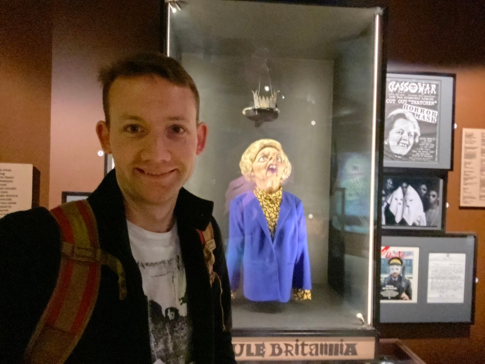 Photo from last year of me wearing my Bauhaus tee in front of a Spitting Image dummy of Margaret Thatcher. From https://jmtd.net/log/the_horror_show/