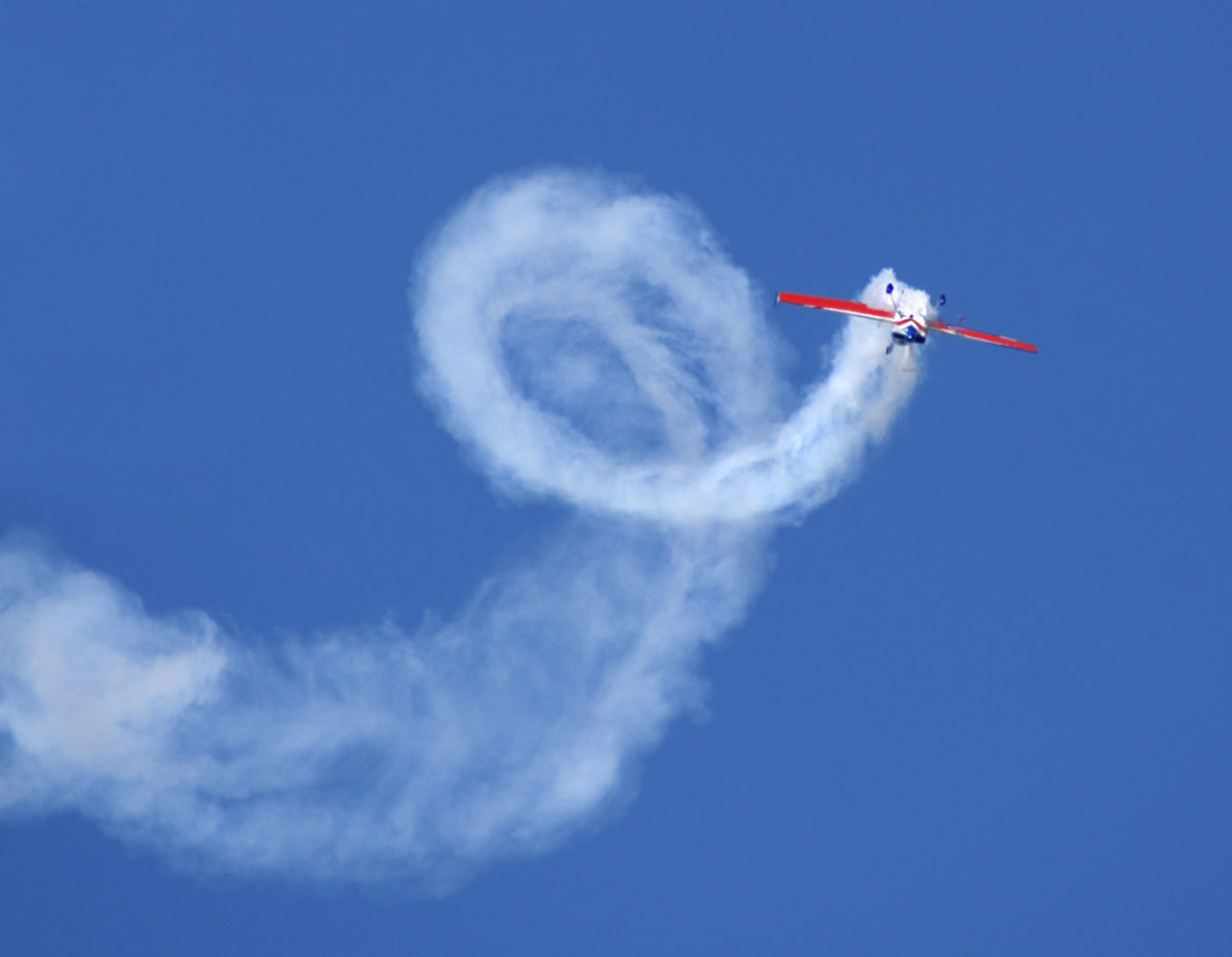 Picture of a stunt plane doing an aileron roll