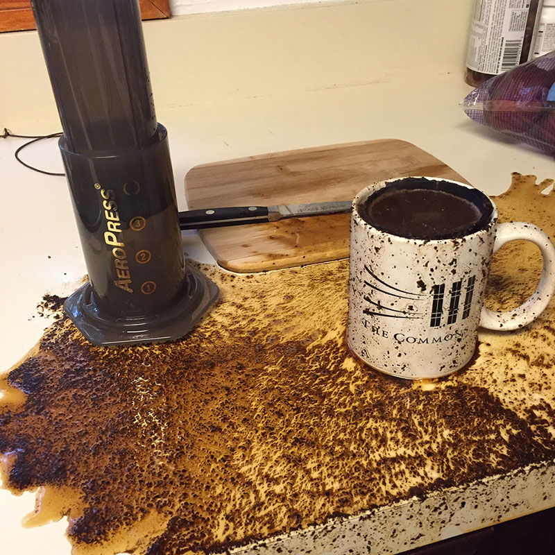 Picture of an aero press pour with coffee messed up everywhere after push