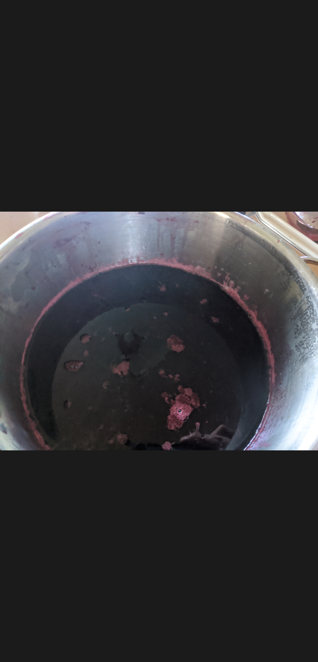 A steel pot with red Elderberry juice in it. 