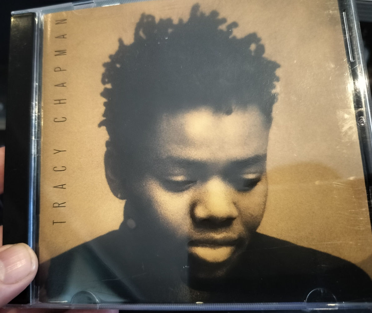 Album cover of Tracy Chapman self-titled album. She looks sad on the album cover.