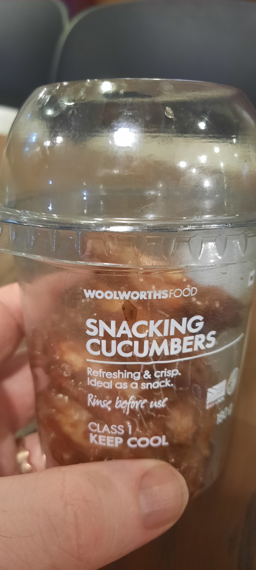 A plastic container with the caption "snacking cucumbers" containing chicken wings