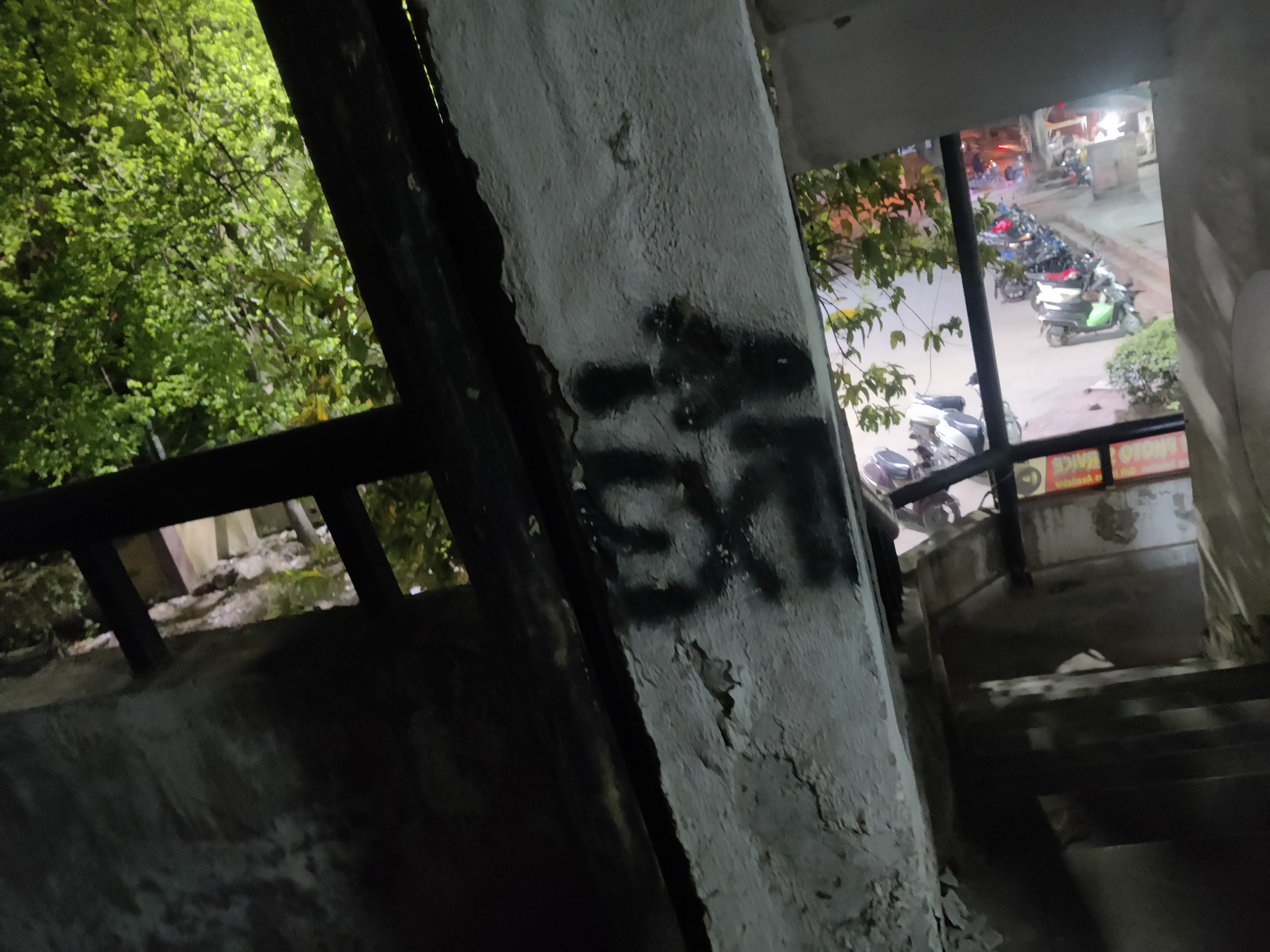 Picture depicting an open stairwell with a tree and a market in the background, with a squished exit and a pointing arrow towards the stairwell